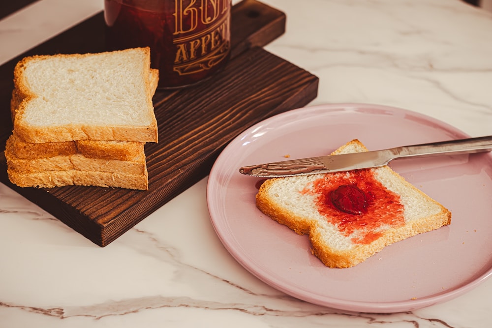 a piece of bread on a plate with jam on it