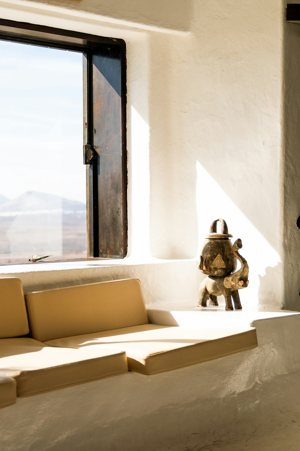 a stuffed animal sitting on a bench in front of a window