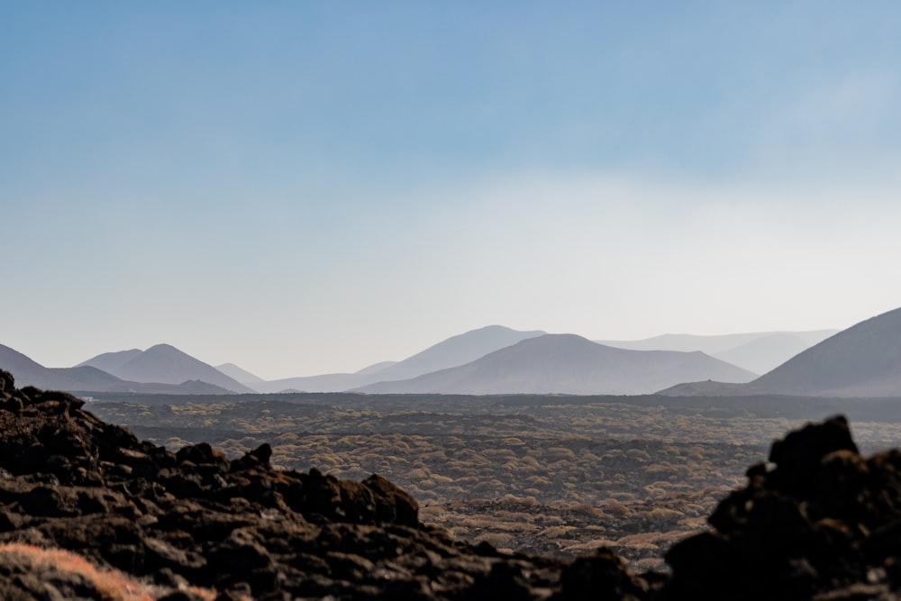 a view of mountains from a rocky outcropping