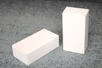 a white box and a white box on a gray surface