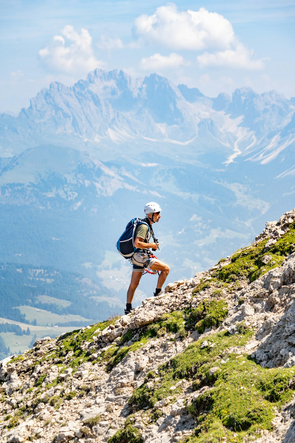 a man hiking up a mountain with a backpack