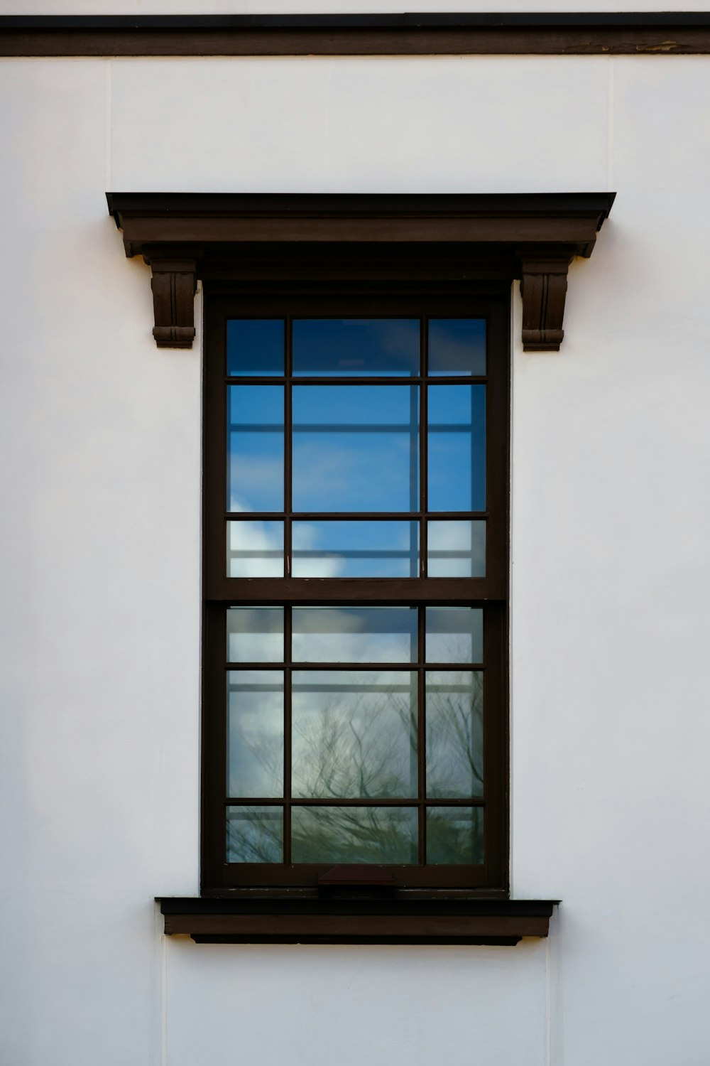 a white building with a black window and a clock