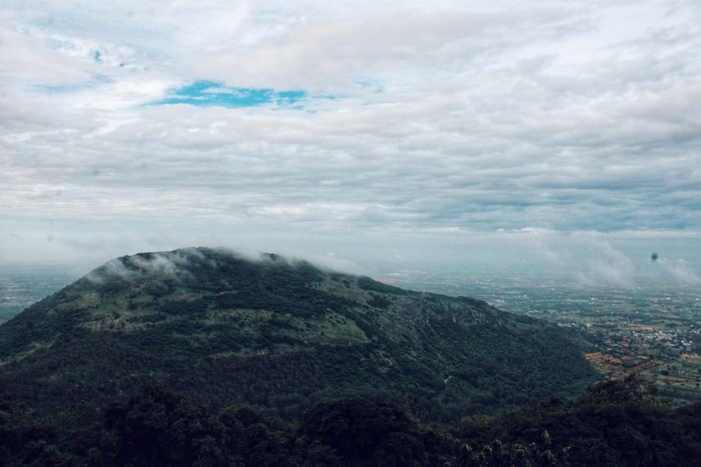 a view of a mountain with clouds in the sky