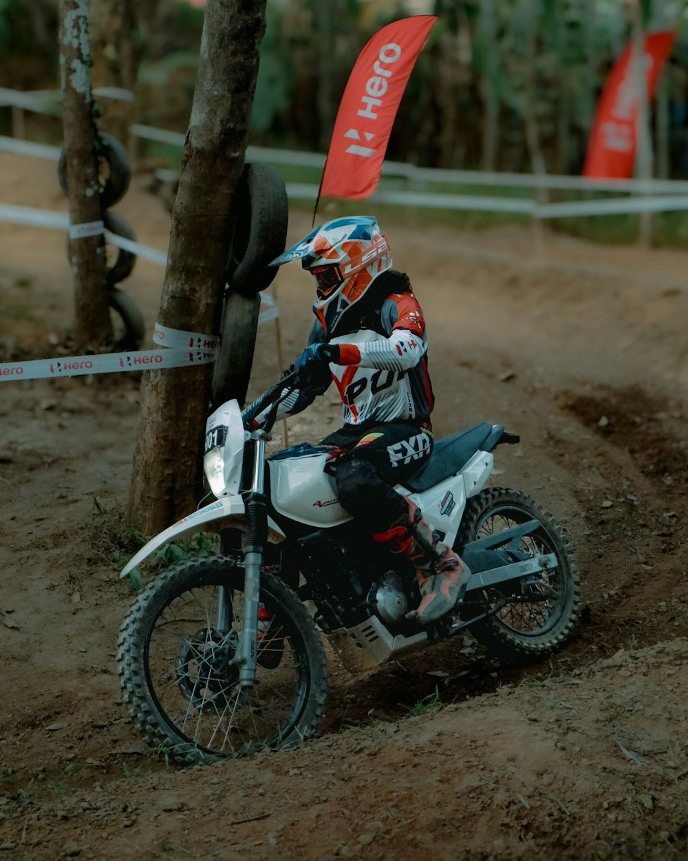 a person riding a dirt bike on a dirt track