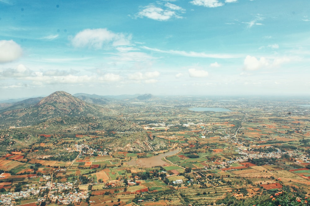 an aerial view of a city with a mountain in the background