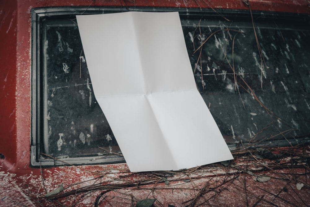 a piece of paper hanging from the side of a window
