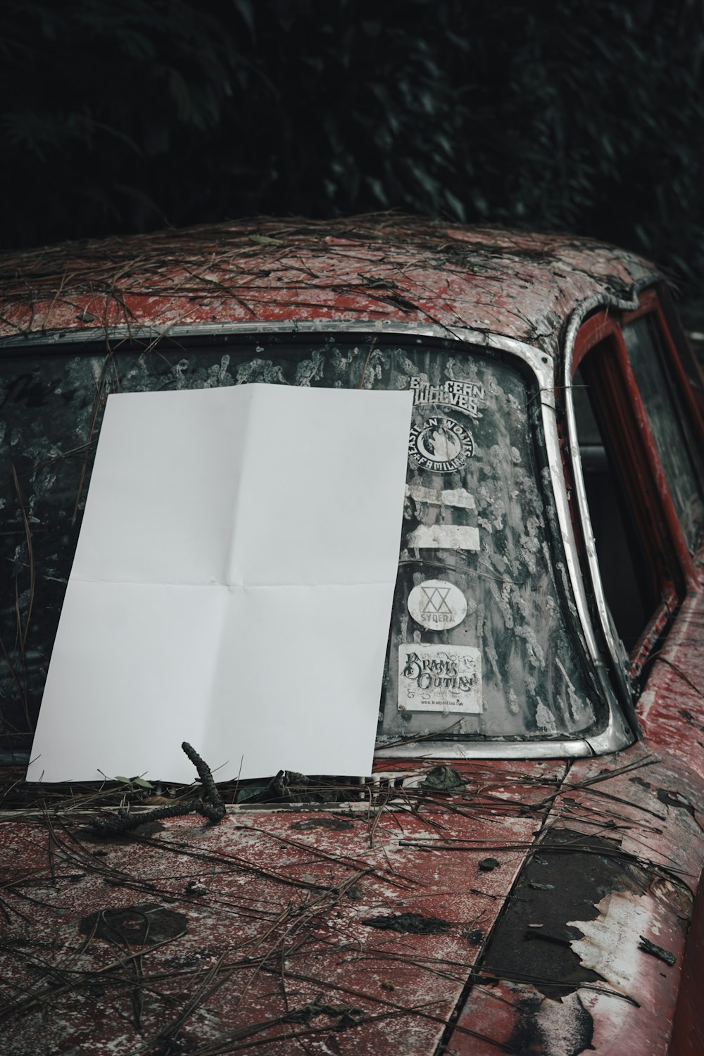 a piece of paper sitting on the hood of a car