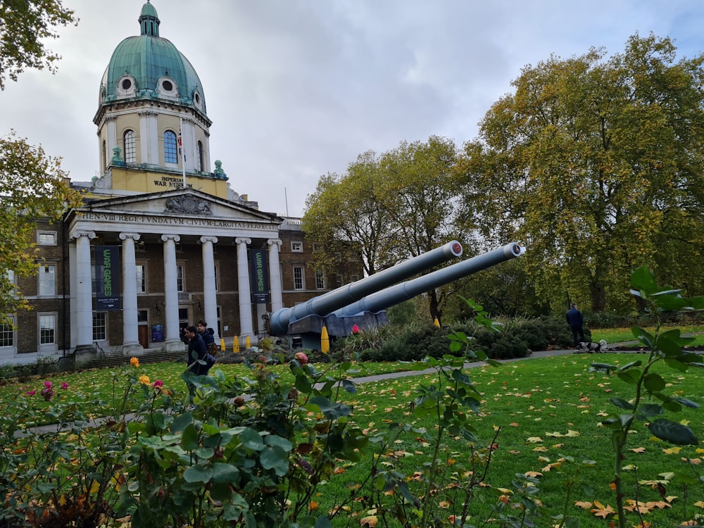 a large cannon sitting in front of a building