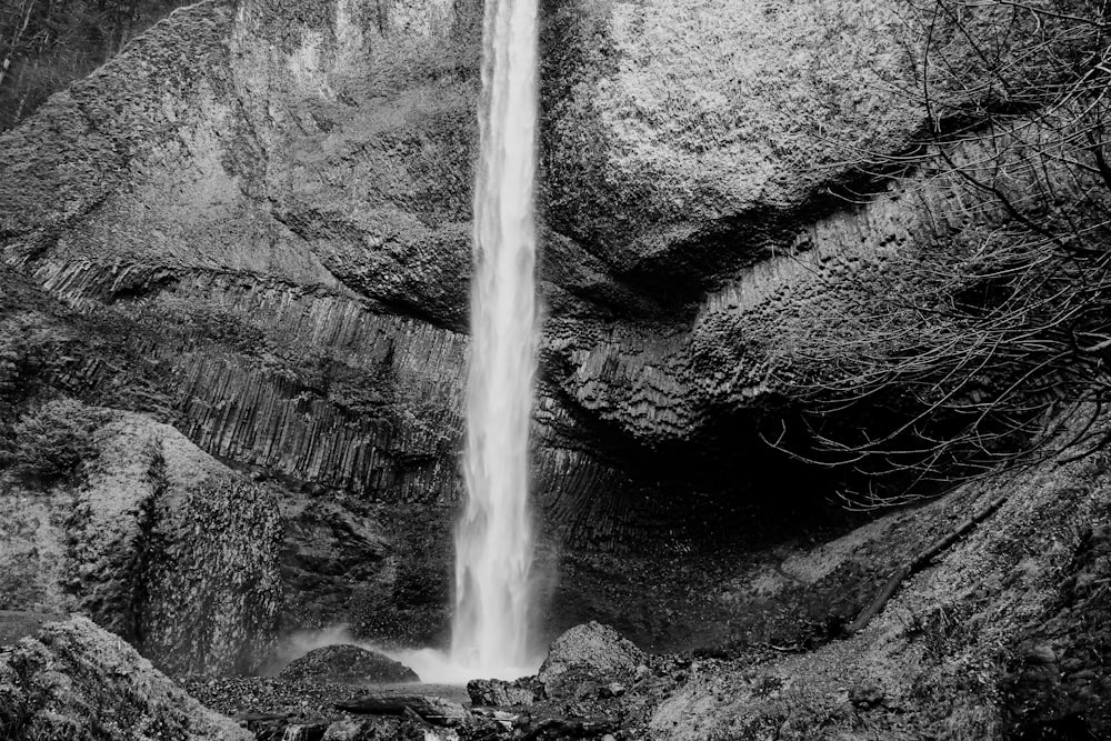 a black and white photo of a waterfall