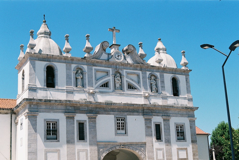 a large white building with a clock on the top of it