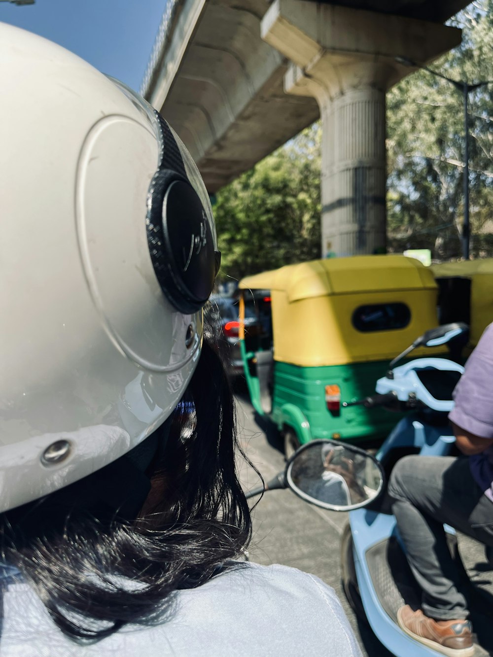 a man riding a scooter with a helmet on