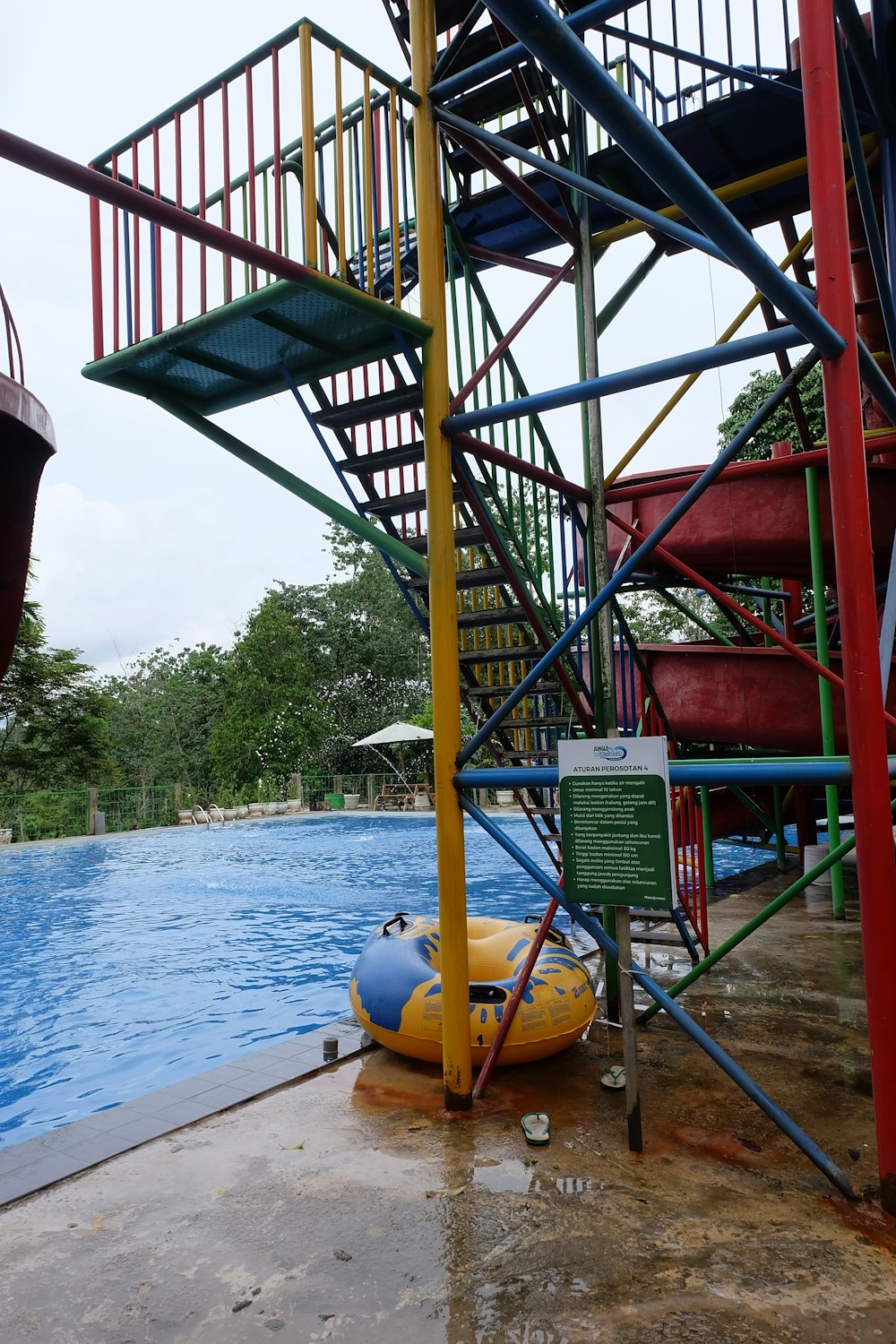 a water slide next to a swimming pool