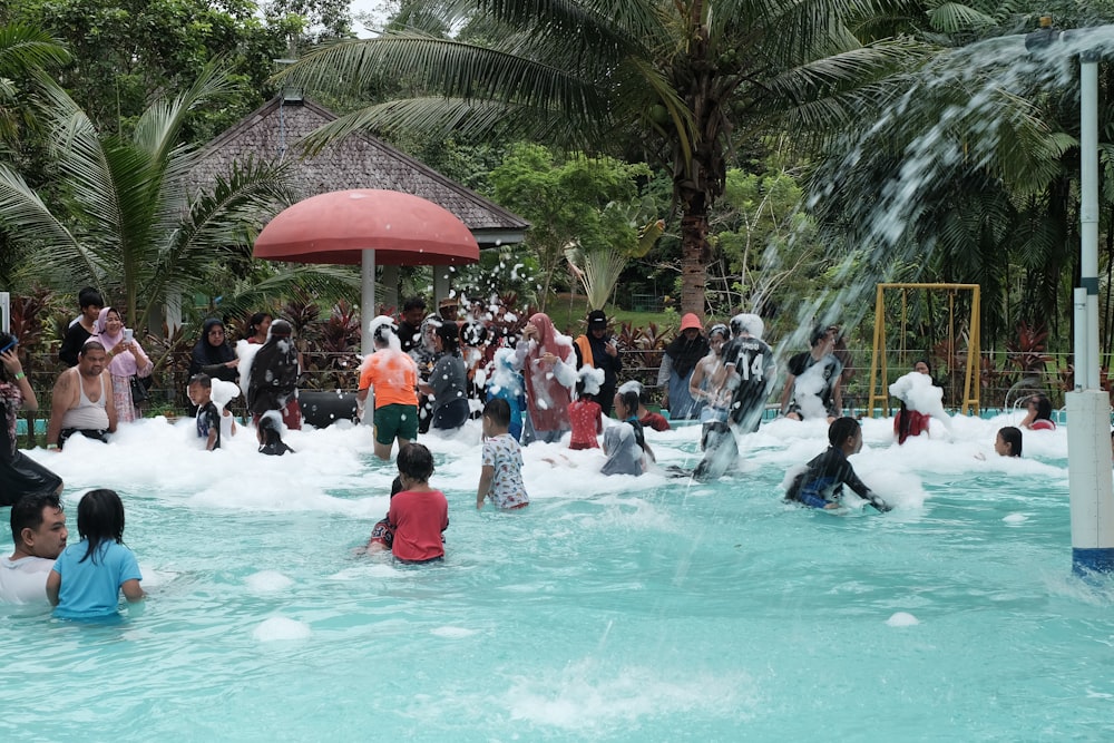 a group of people playing in a water park