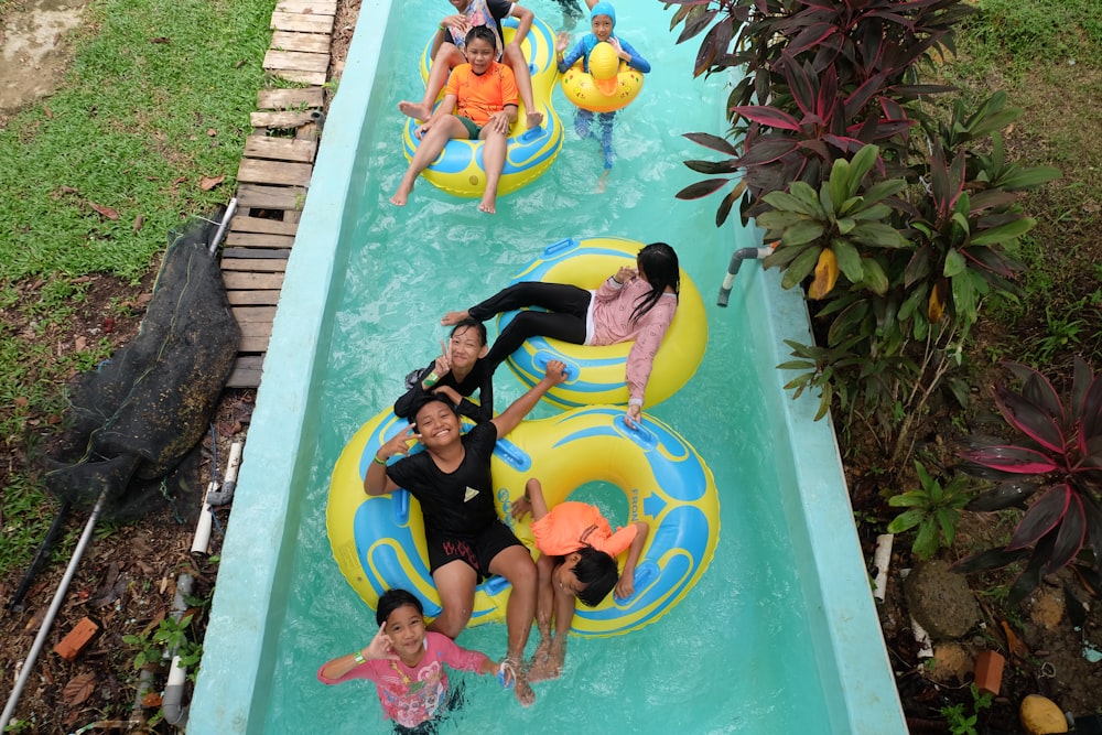 a group of people riding on top of an inflatable raft