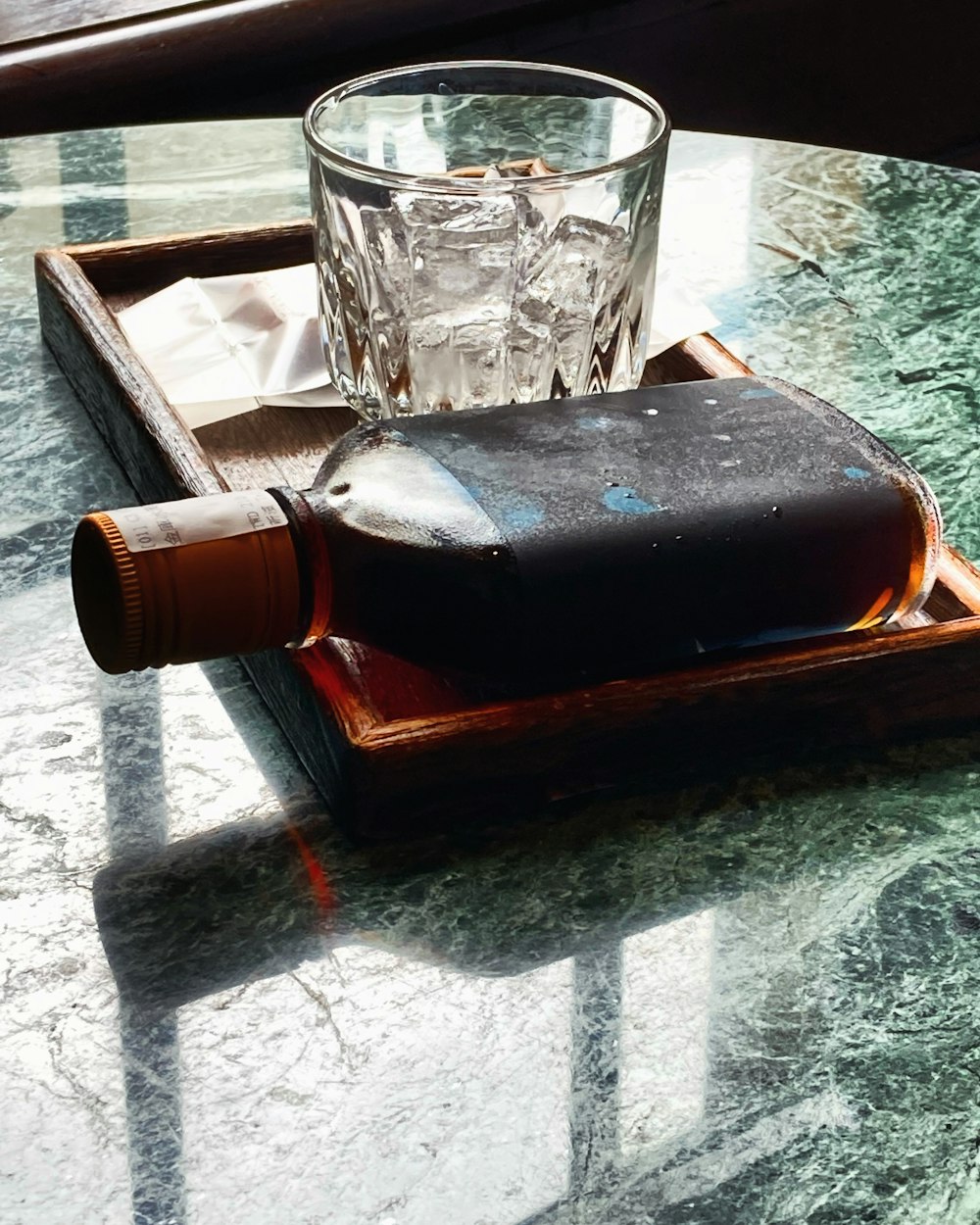 a bottle of alcohol and a glass on a table