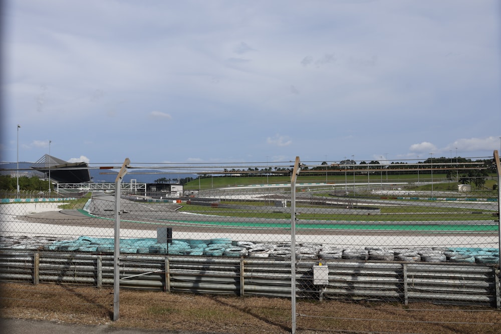 a view of a race track from behind a fence