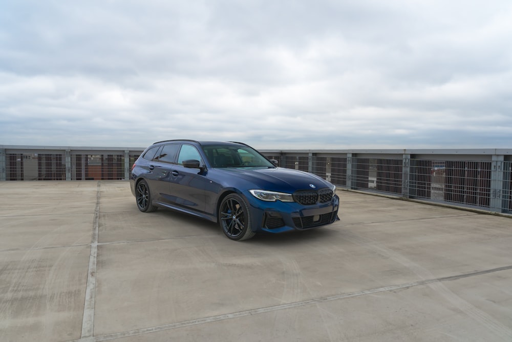 a blue car parked in a parking lot