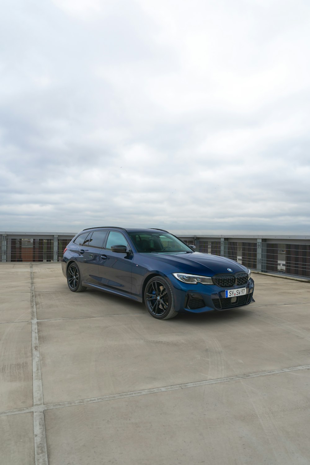 a blue car parked in a parking lot