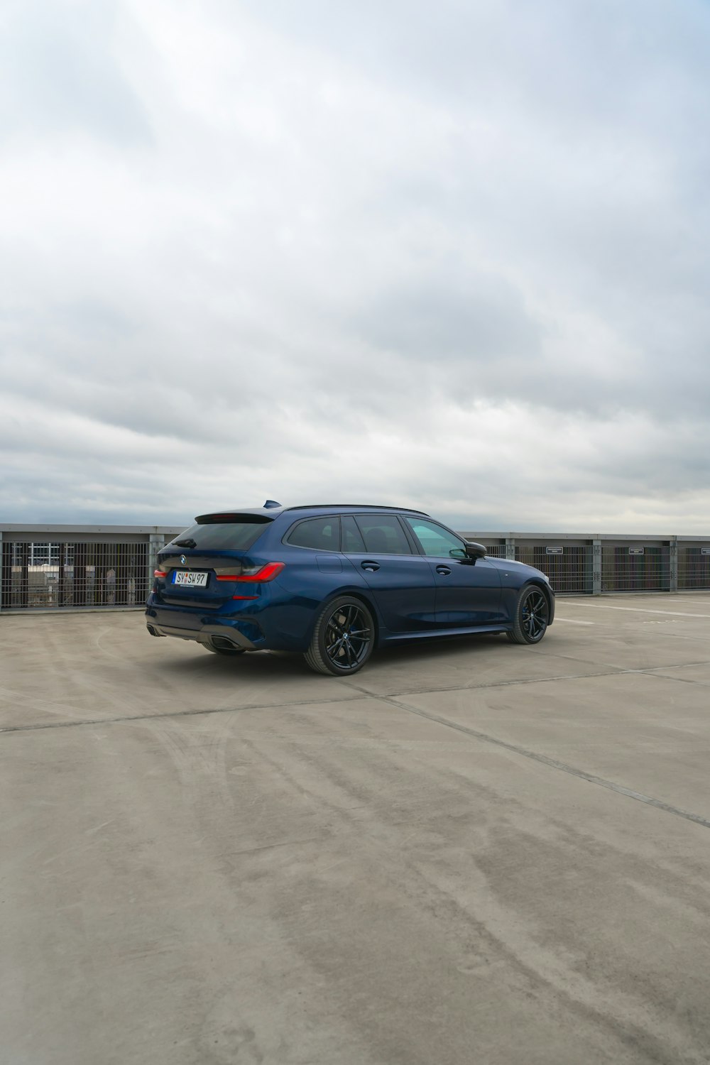 a blue car parked in a parking lot