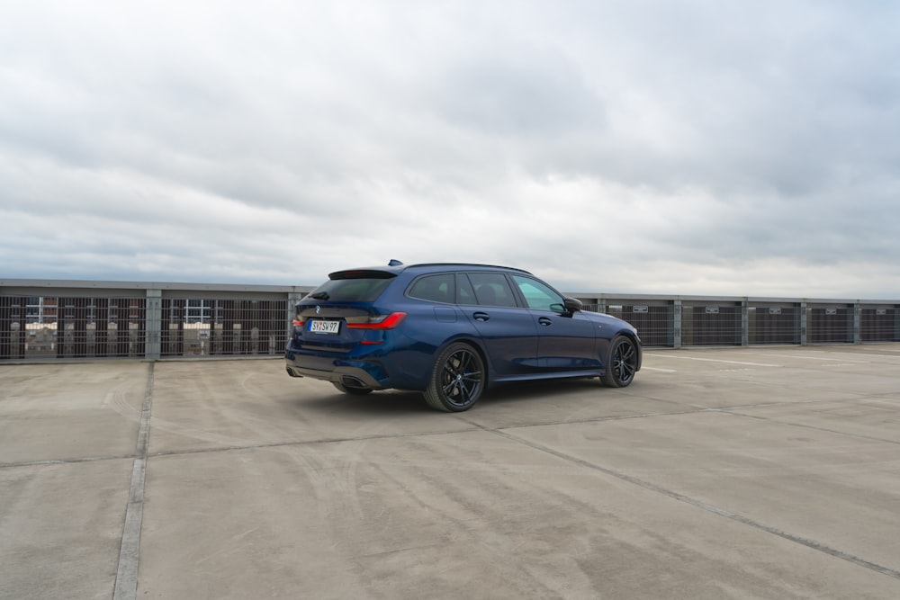 a blue car parked in a parking lot