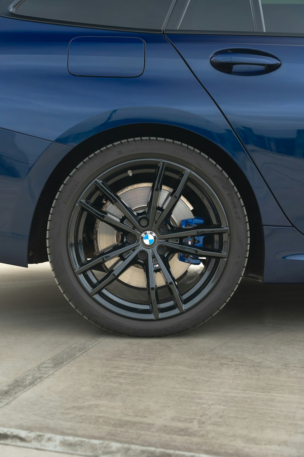 a close up of a bmw wheel on a blue car