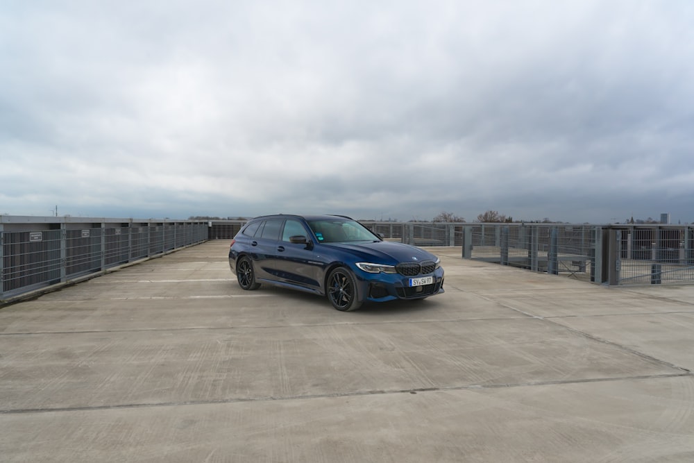 a blue car parked in a parking lot