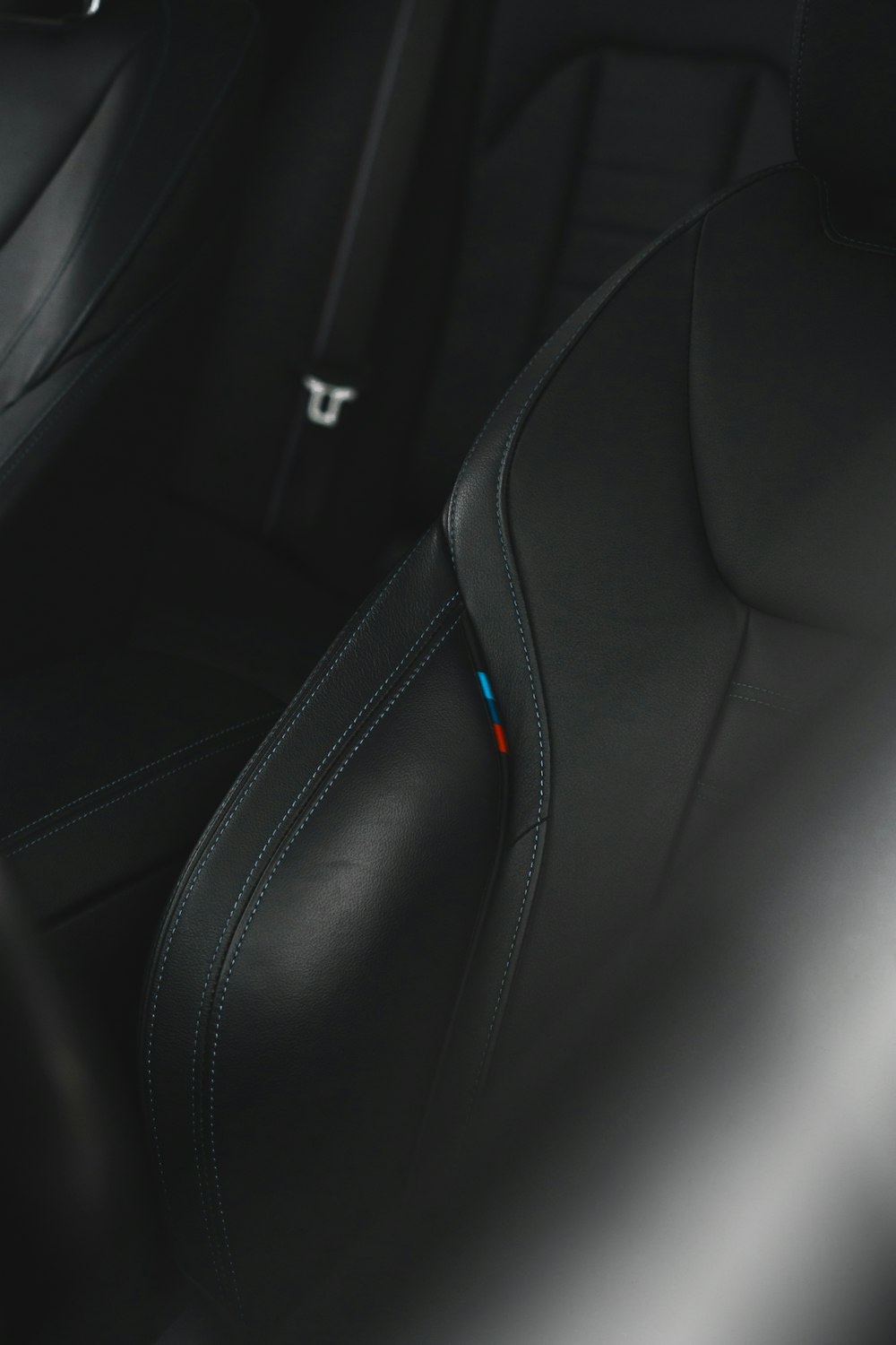 the interior of a car with black leather