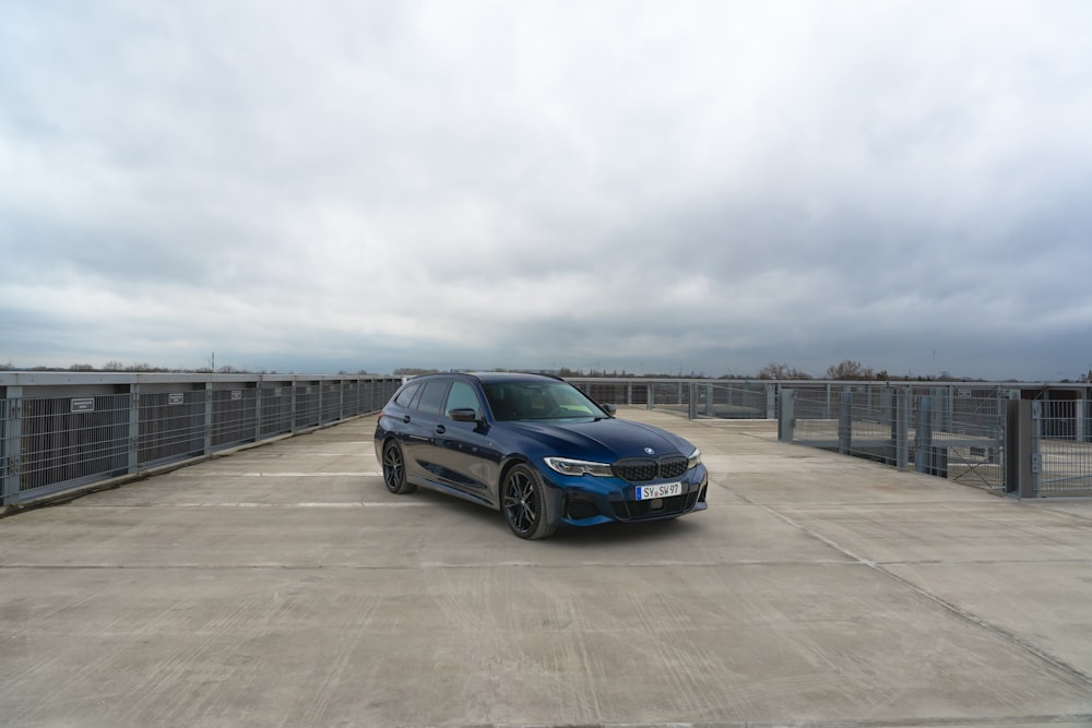 a blue car parked in a parking lot