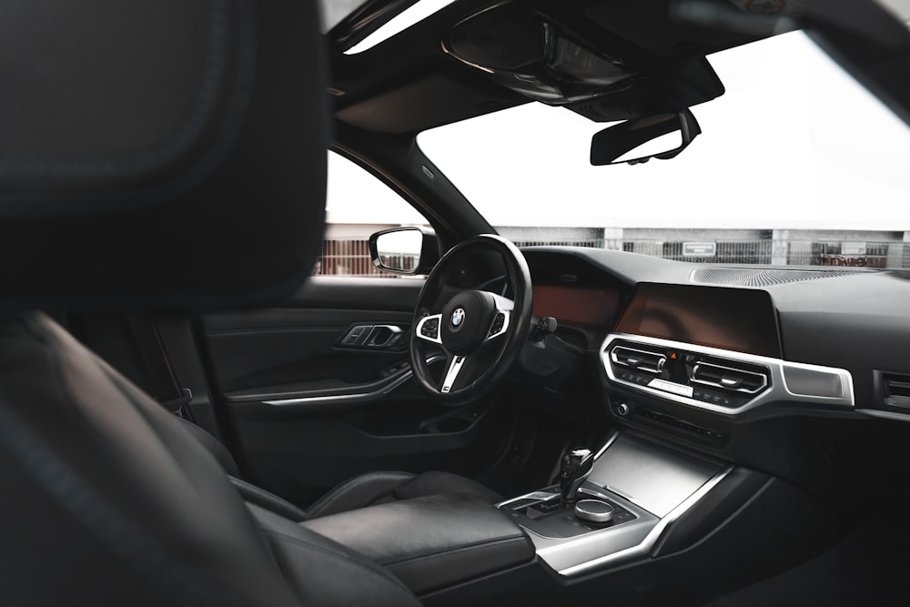 the interior of a car with a steering wheel and dashboard