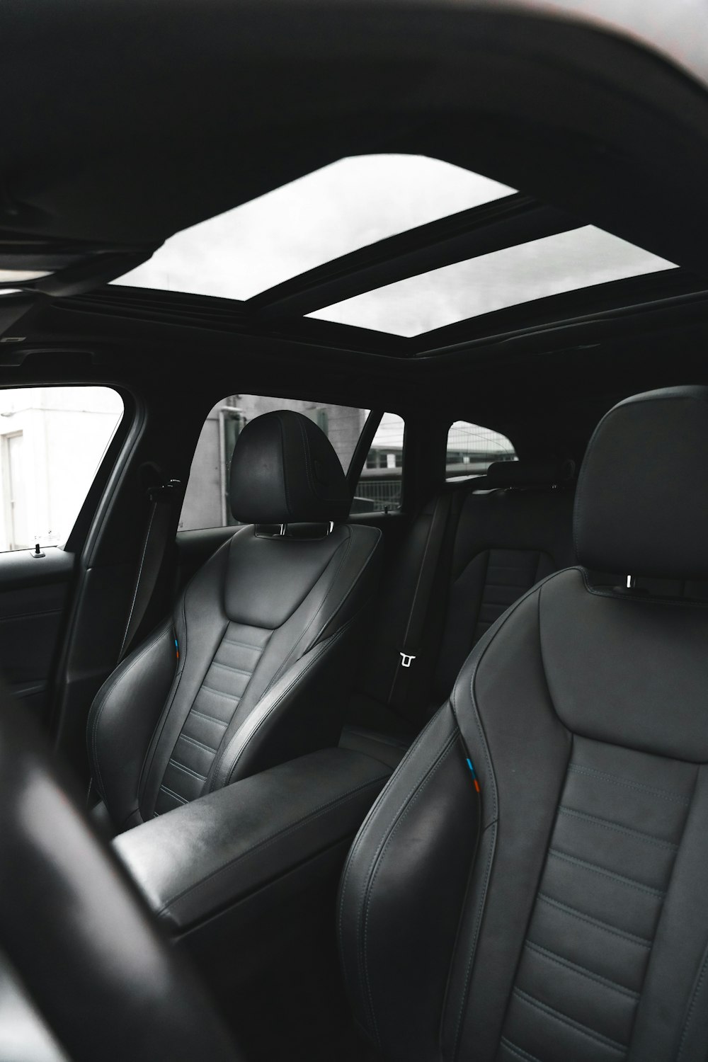 the interior of a car with black leather seats