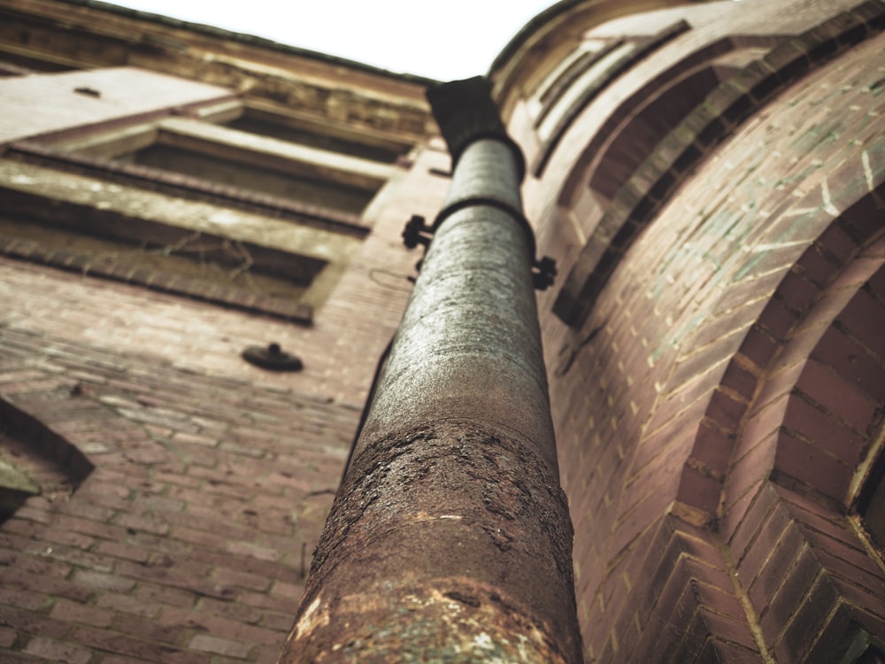 a large pipe is in front of a brick building