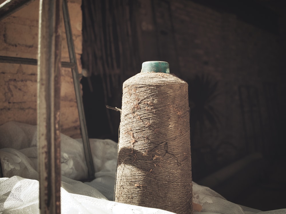 a large bottle sitting on top of a pile of paper