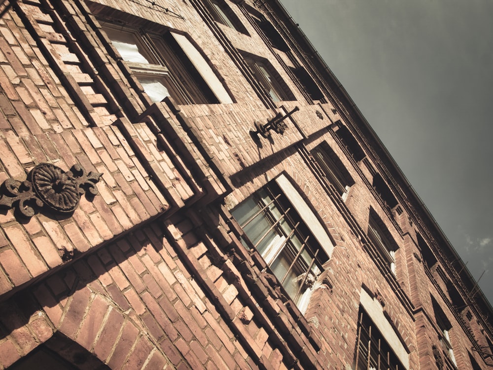 a tall brick building with a clock on the side of it