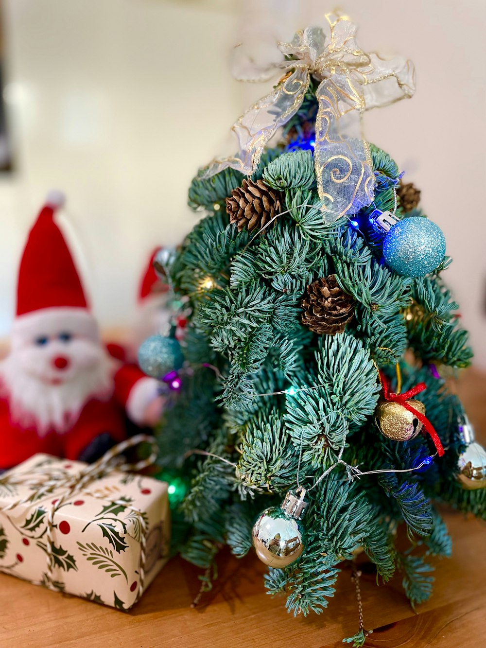 a small christmas tree sitting on top of a wooden table