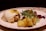 a white plate topped with food and vegetables