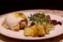 a white plate topped with food and vegetables