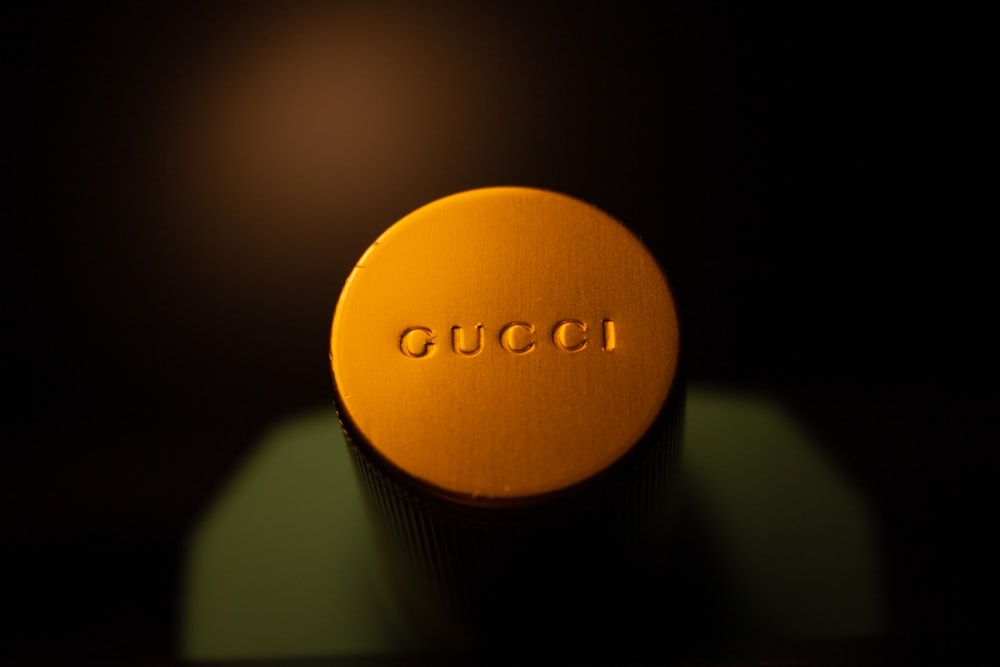 a close up of a bottle of gucci on a table