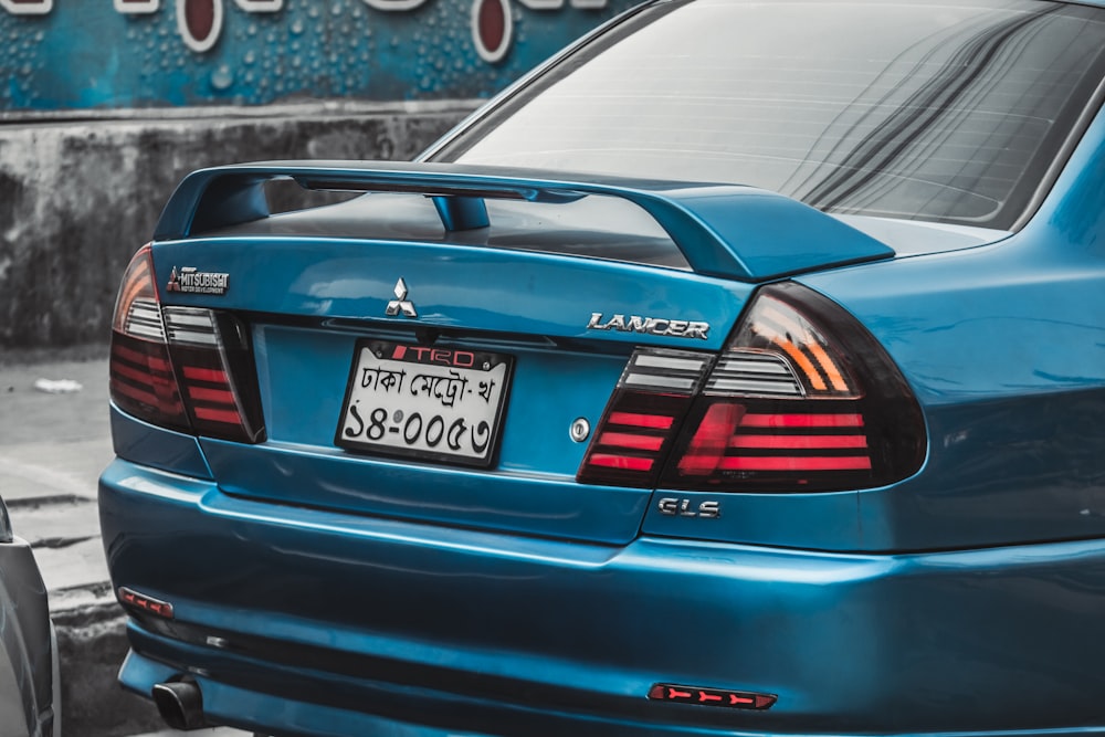 a blue car parked on the side of the road