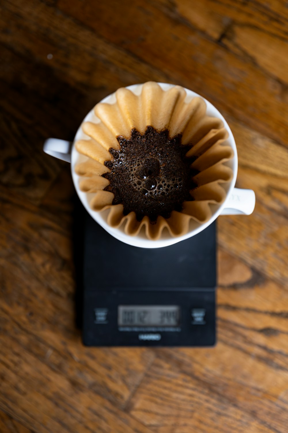 a cup of coffee sitting on top of a scale
