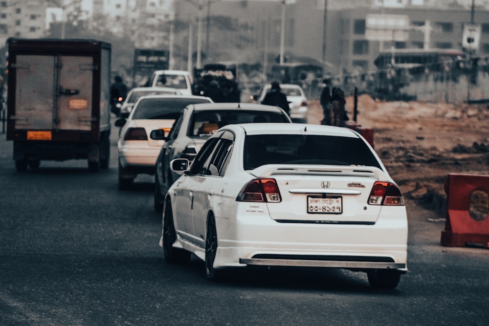 a group of cars that are sitting in the street