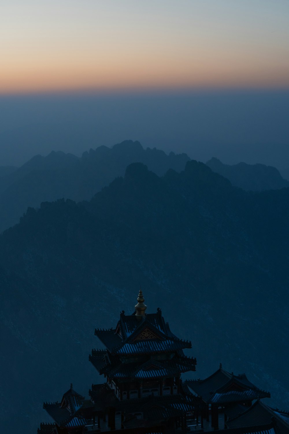 a view of a mountain with a building in the foreground