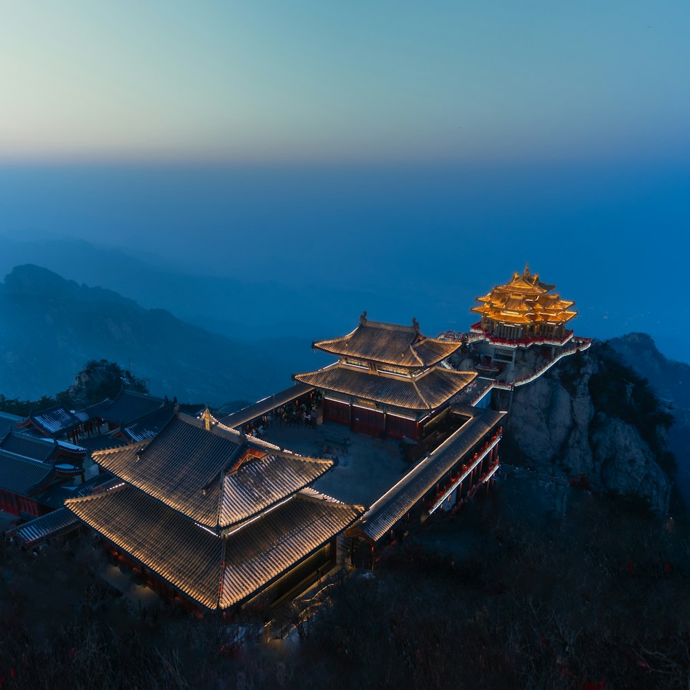 a building on top of a mountain with a sky background