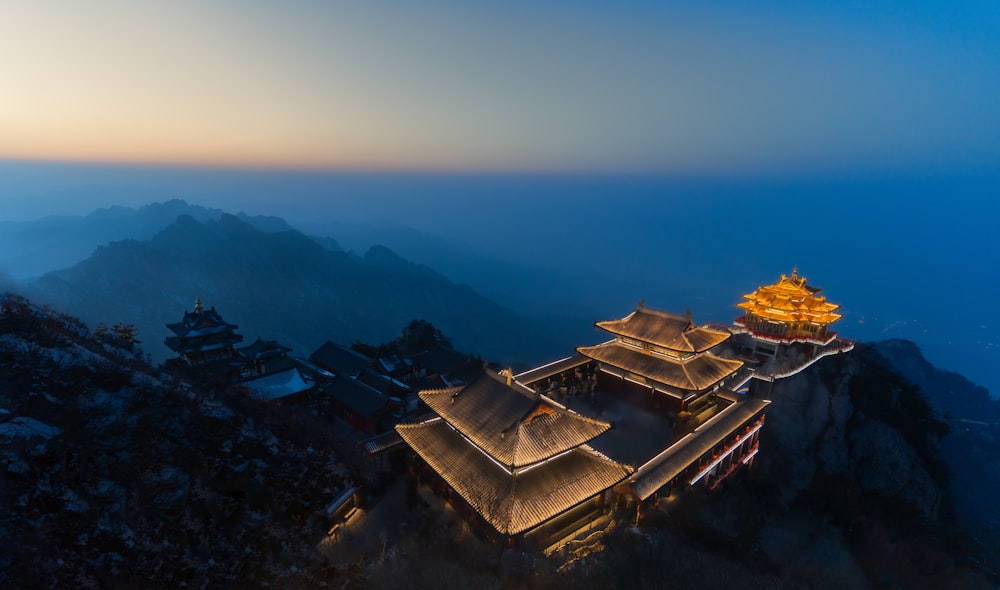 a building on top of a mountain with a sky background