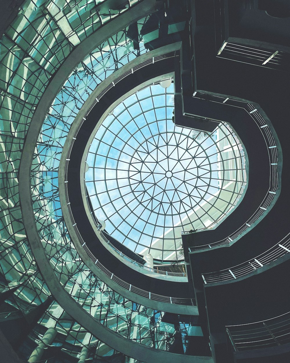 a spiral staircase with a skylight in the center