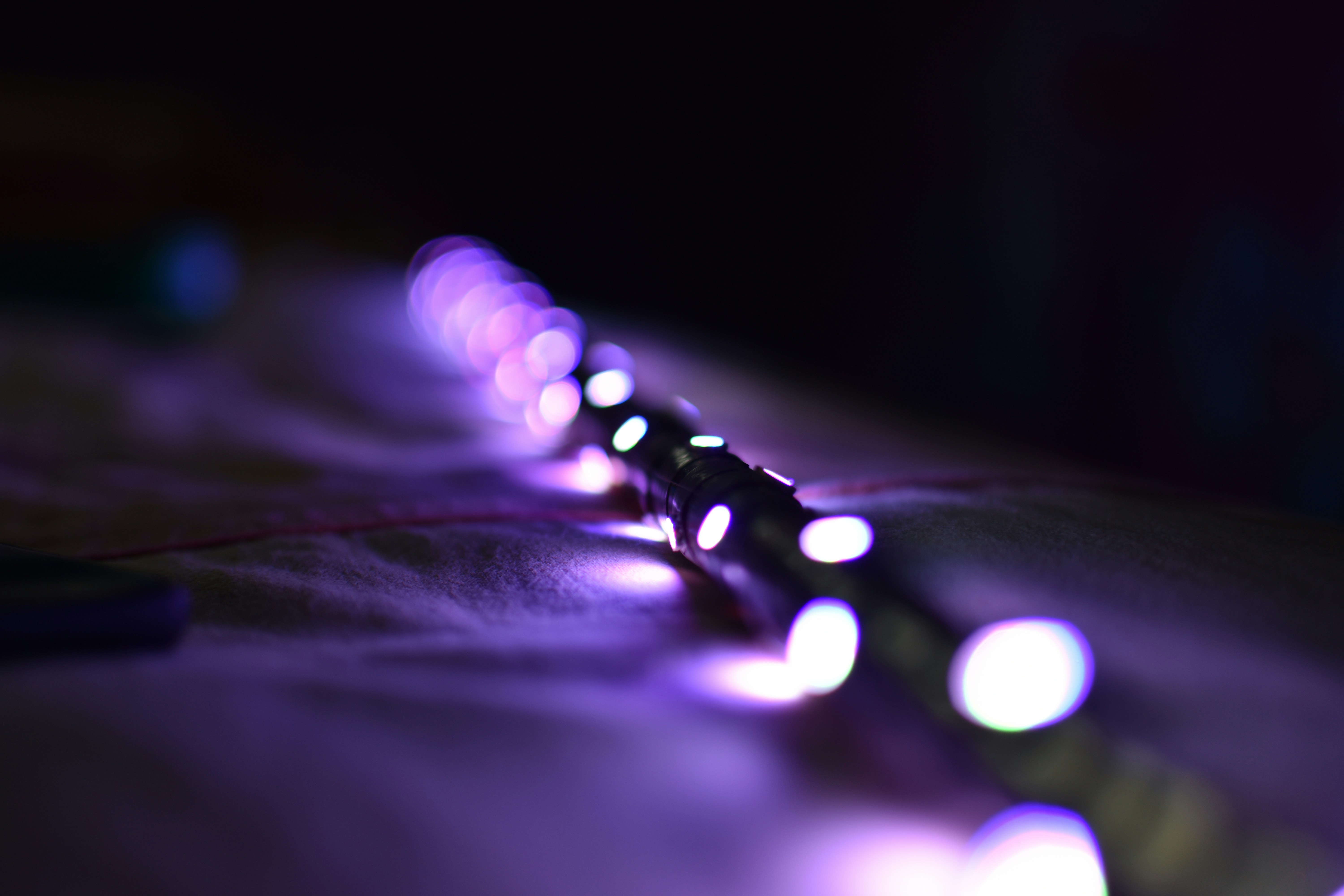 a close up of a string of lights on a bed
