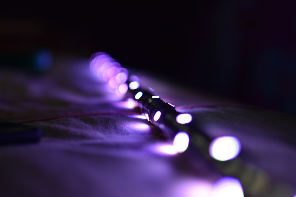 a close up of a string of lights on a bed