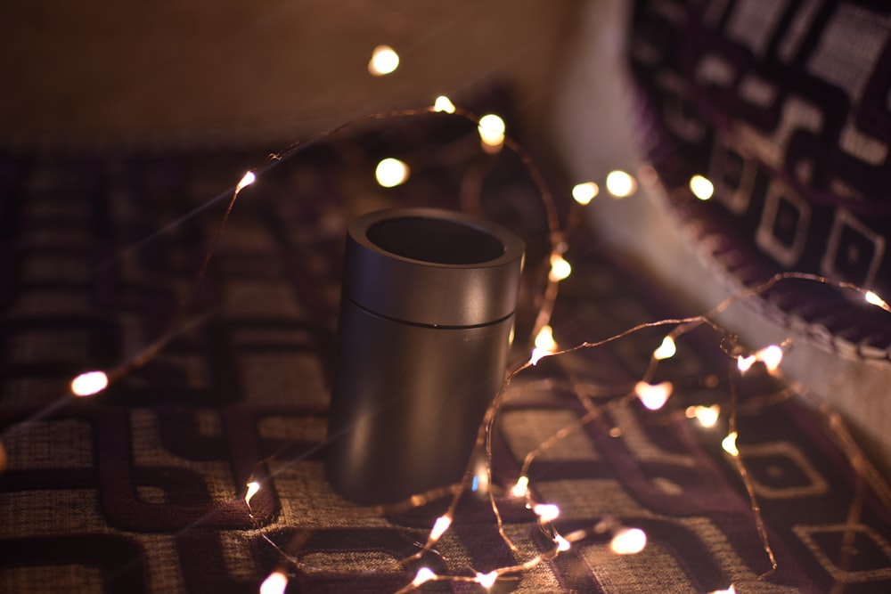 a speaker sitting on top of a table covered in lights