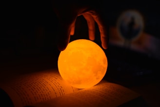 a person holding a glowing ball in their hand