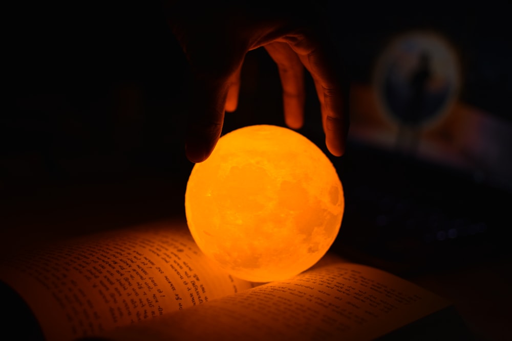 a person holding a glowing ball in their hand