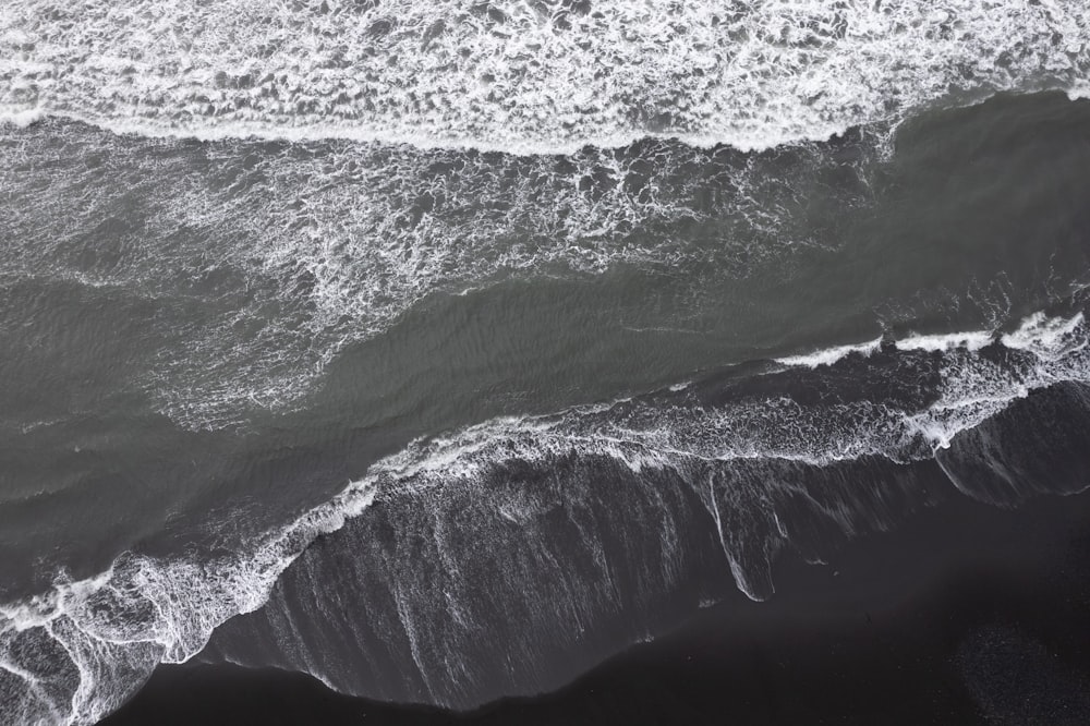 Une photo en noir et blanc des vagues de l’océan